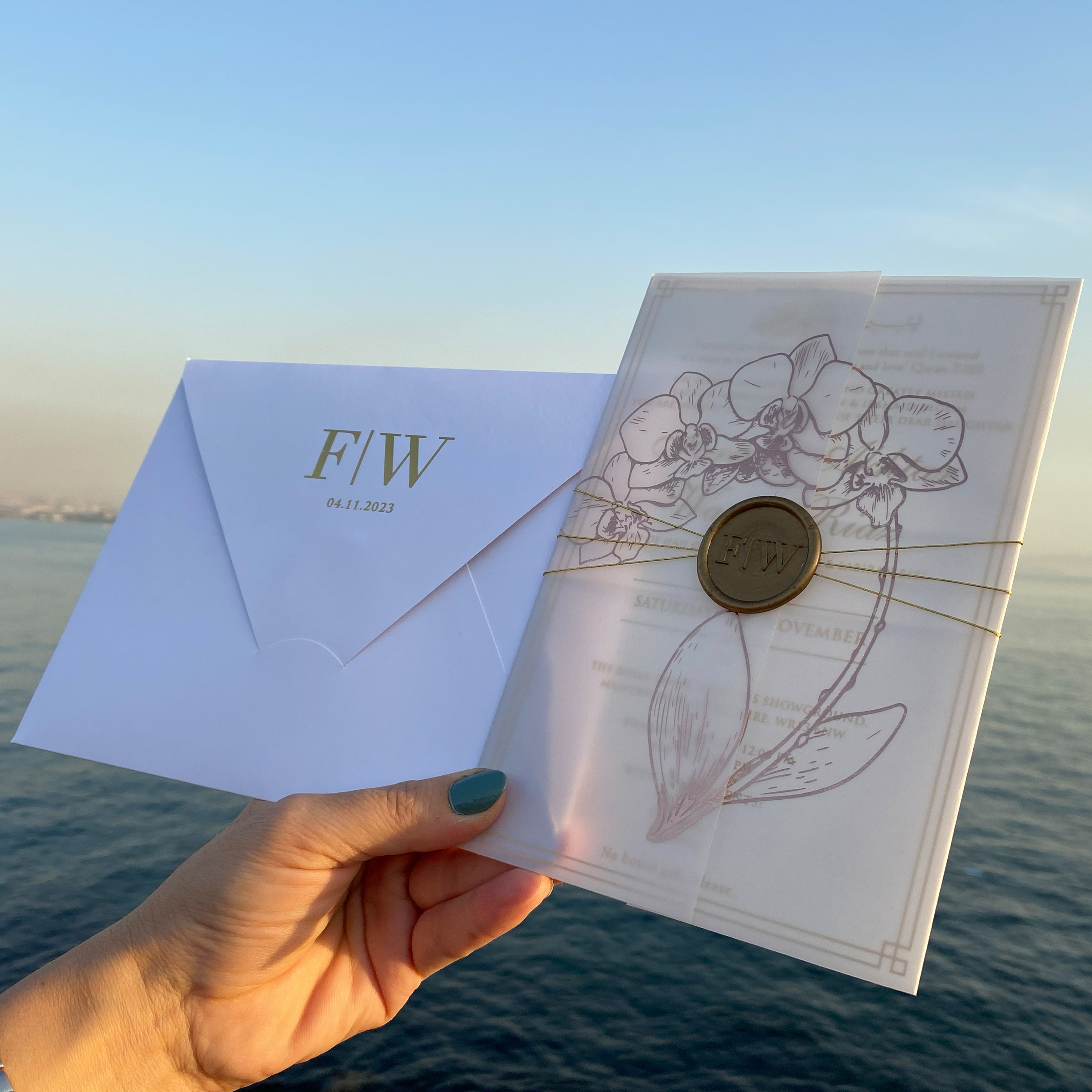 Frosted acrylic wedding invitation. Printed parchment wrapping. Wax seal. Rose gold foil printing 